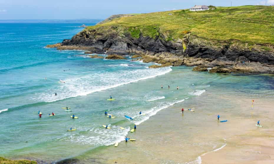 Poldhu Cove beach with surfers