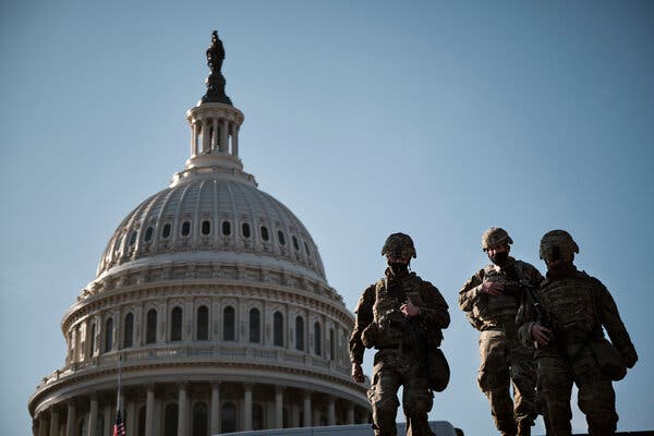 Armed National Guard members walk around the grounds of the U.S. Capitol in January.