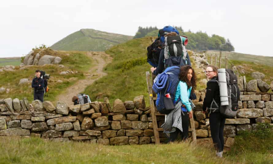 People walking Hadrian’s Wall, UK.