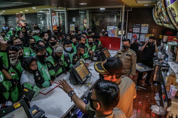 A throng of delivery riders at a McDonald’s in Bogor, Indonesia, on Wednesday. The country has one of the highest coronavirus caseloads in Asia and has seen a surge of infections in recent weeks.