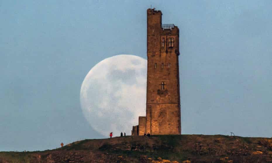 Almost full ‘super moon’ behind Victoria Tower on Castle Hill in Huddersfield, England.