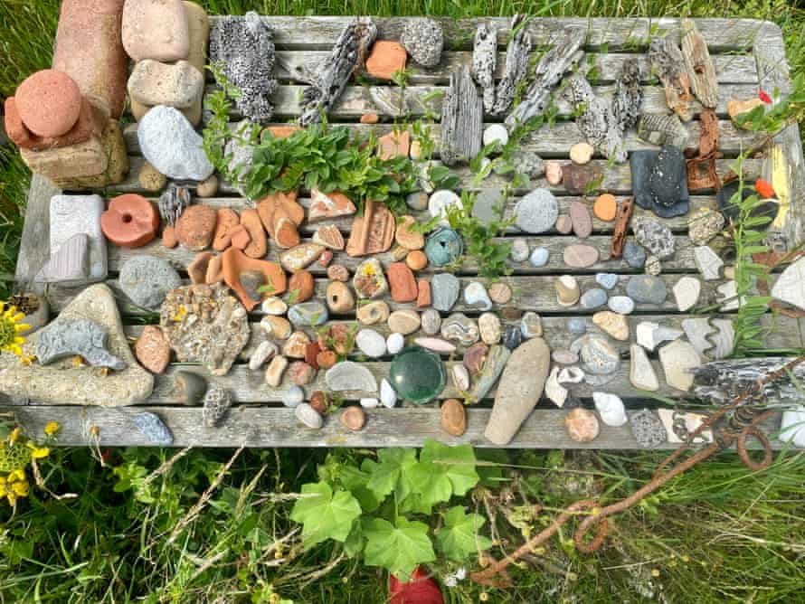 A table of foreshore treasures (stones, pebbles etc) at Shingle Street. Suffolk-Essex coast, UK.