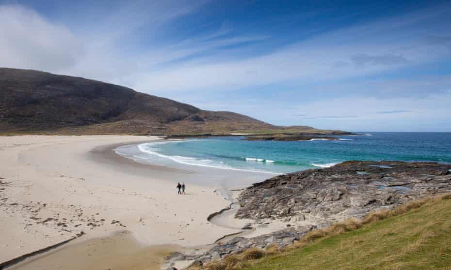 A couple walking on Tangasdale Beach,  Barra