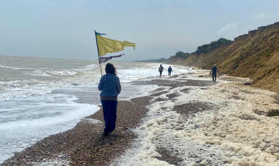 Walking on the coast south of Lowestoft. The spume is generated by algae in the water