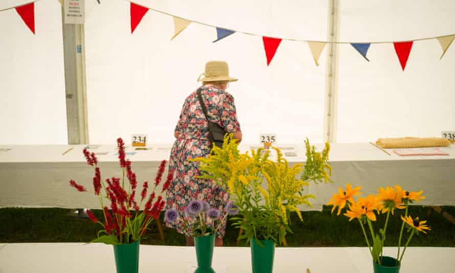 A lady in a flowery Summer dress at a flower show