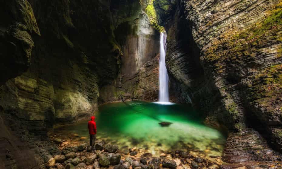 Man in front of Kozjak waterfall, Soca Valley, Slovenia.