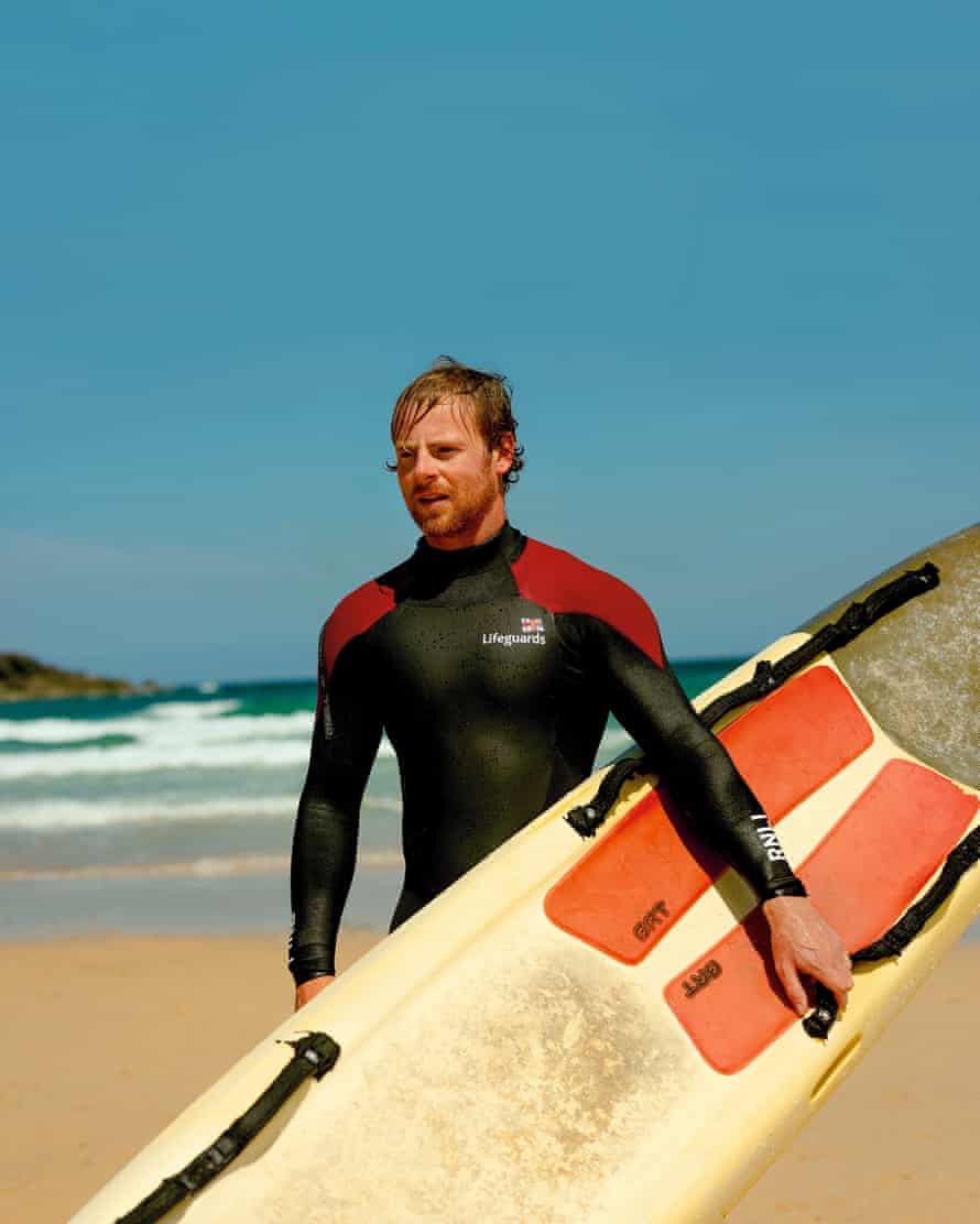 A surfer holding his board