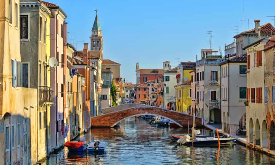 Great water view of Chioggia with vintage cabins and bridgeChioggia, little Venice in Italy