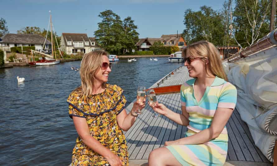 Two women with champagne on deck