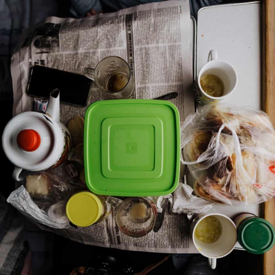 Tupperware, cups and pots are stacked on the small tables