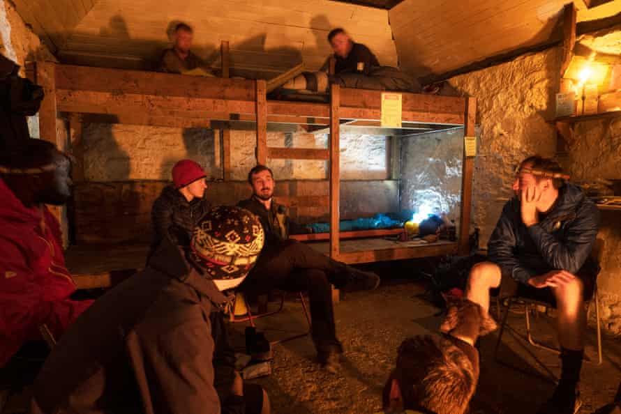 A group of mountain bikers warm by fire at Lairig Leacach Bothy where they camped the night. Lairig Leacach is on the old drovers road linking the Great Glen with the south. It has been maintained by the MBA since 1977 and is popular with walkers and cyclists who travel through the pass or who are climbing the hills in the Grey Corries range.The Mountain Bothy Association charity have reopened their 105 mountain huts, shelters and howffs after a year of closure due to covid. The overwhelming majority of these are in Scotland and they reopened in August for what the MBA described as “responsible use” pointing out that covid has not gone away. The bothies are all sorts of shapes and sizes in varied locations many extremely remote maintained with the agreement of owners and estates and maintained by MBA volunteers since the late 60’s and early 70’s