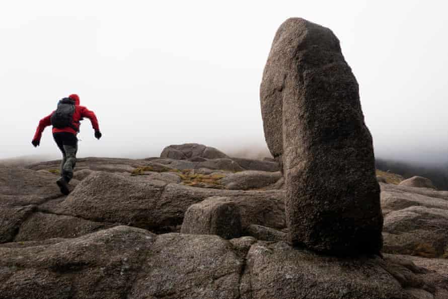 Graeme Marshall practises his bouldering skills on the way to Leabaidh an Daimh Bhuidhe at the Sneck by Ben Avon in Cairngorms