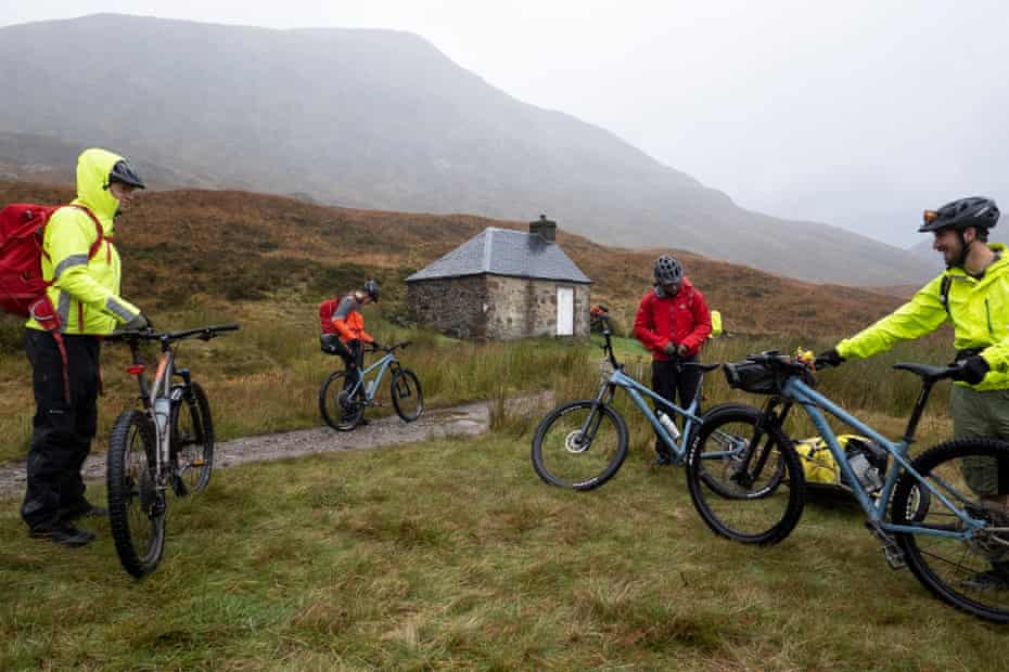 A group of mountain bikers depart Lairig Leacach Bothy where they camped the night.