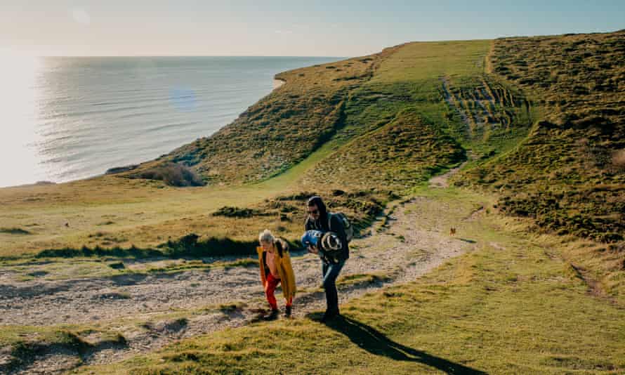 Walkers (and weary dog) taking the cliff path from Cuckmere.