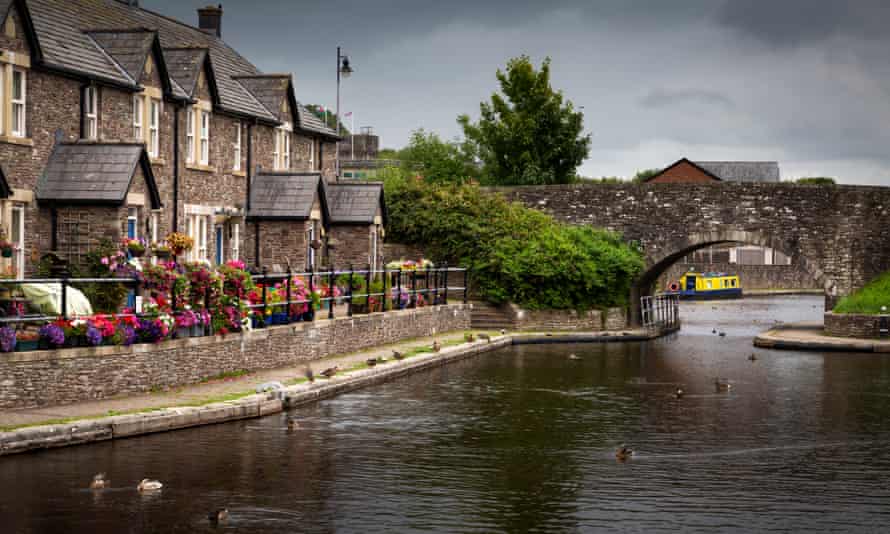 The Brecon Basin CanalEditorial BRECON, UK - JULY 26, 2020: Picturesque houses at the Brecon basin, the start of the The Monmouthshire &amp; Brecon Canal and the Taff Trail in South Wales UK