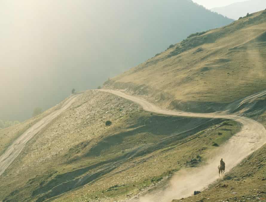 A rider on a horse, on the road that connects lower and upper Omalo